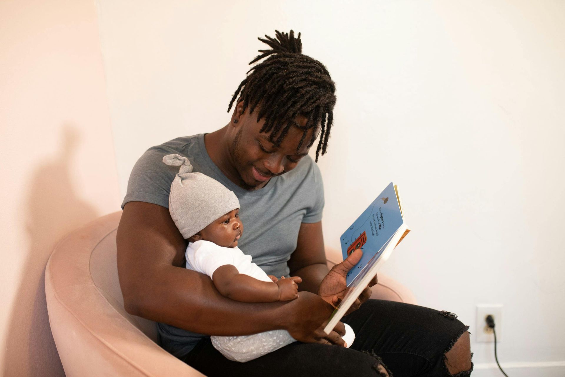 A dad reading a book to his child as part of their bedtime routine