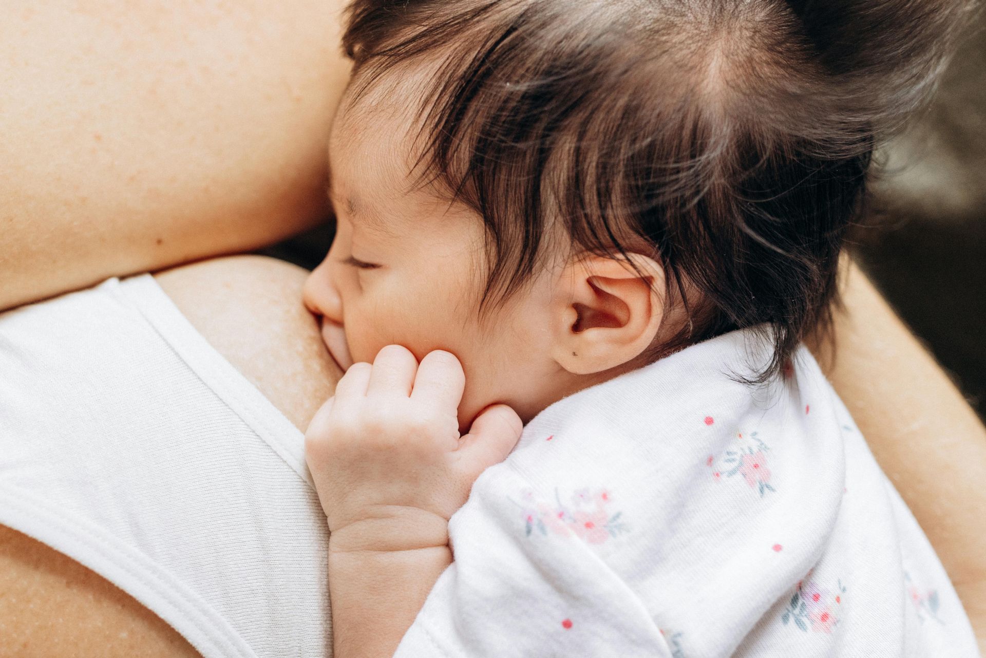 Baby struggling with breastfeeding and falling asleep while nursing.