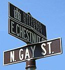A street sign for n. gay st. and e. chestnut st.