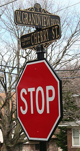 A stop sign is sitting on top of a street sign.