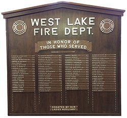 A wooden plaque for the west lake fire department in honor of those who served