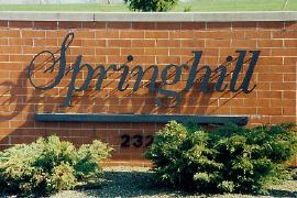 A brick wall with a sign that says springhill on it