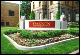 A sign that says gannon in front of a building