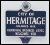 A sign for the city of hermitage is on a white background.