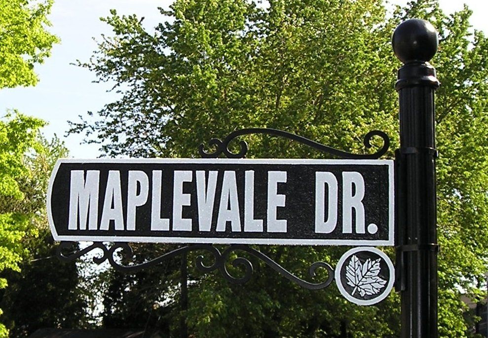 A black and white street sign for maplevale dr.