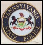 The pennsylvania state police logo is on a coin.