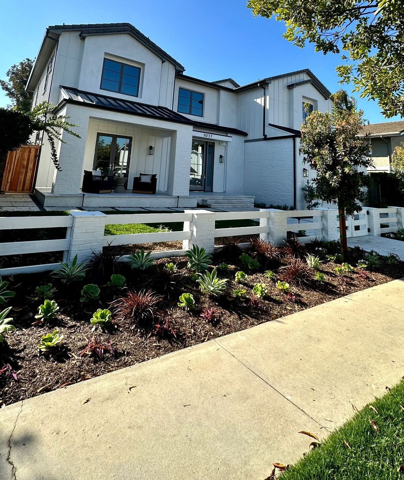 A white house with a white fence in front of it