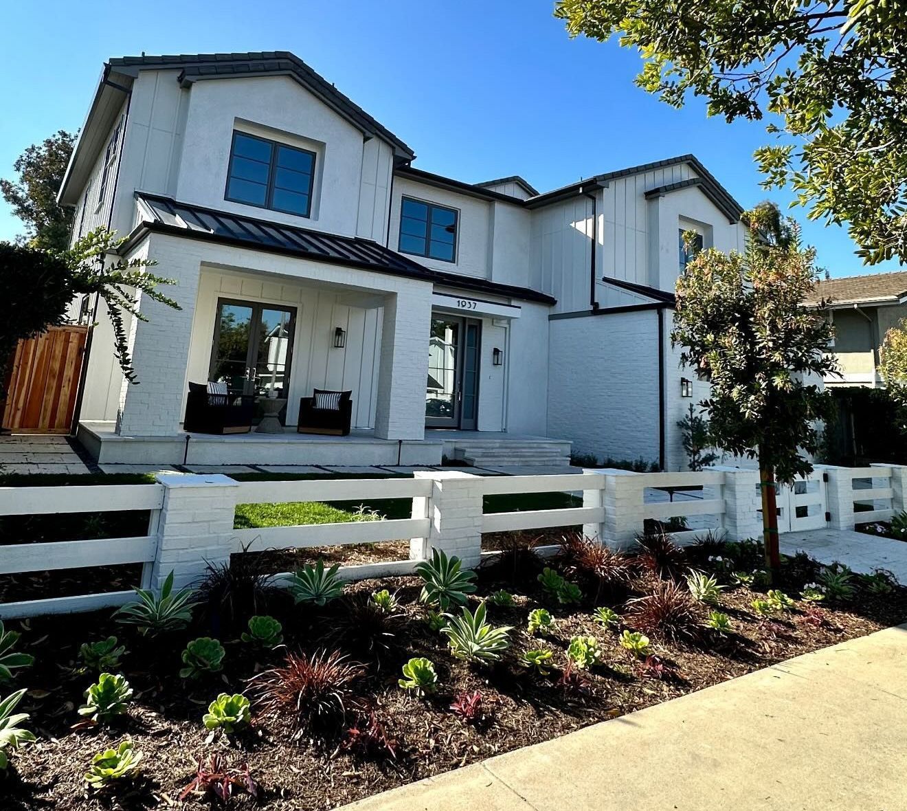 A large white house with a white fence in front of it