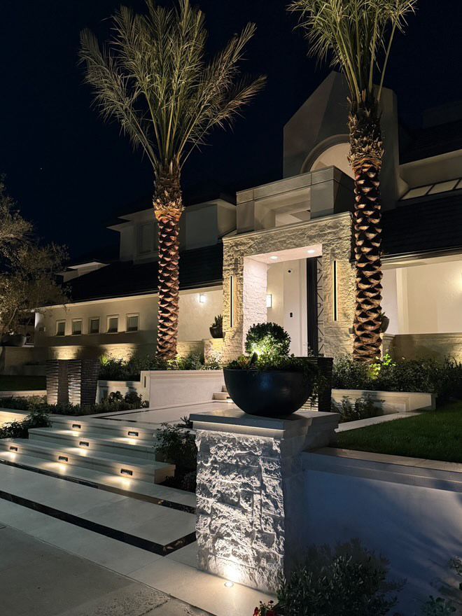 A patio with a fire pit and a pergola in the backyard.