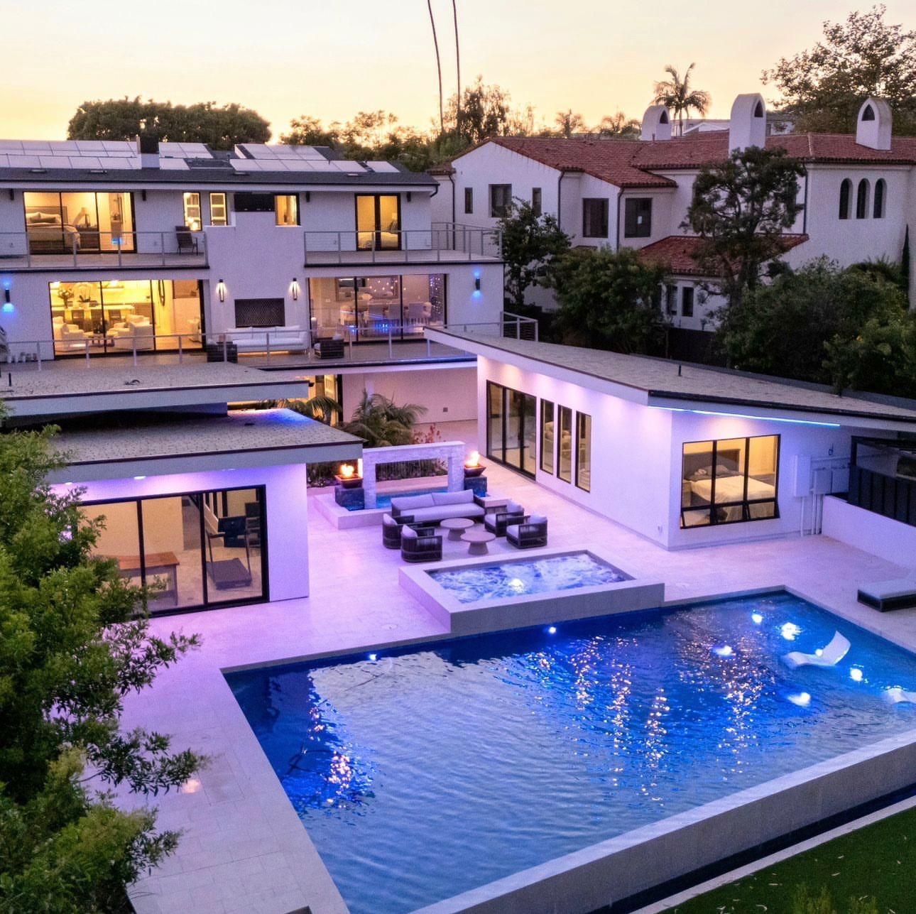 An aerial view of a house with a large swimming pool