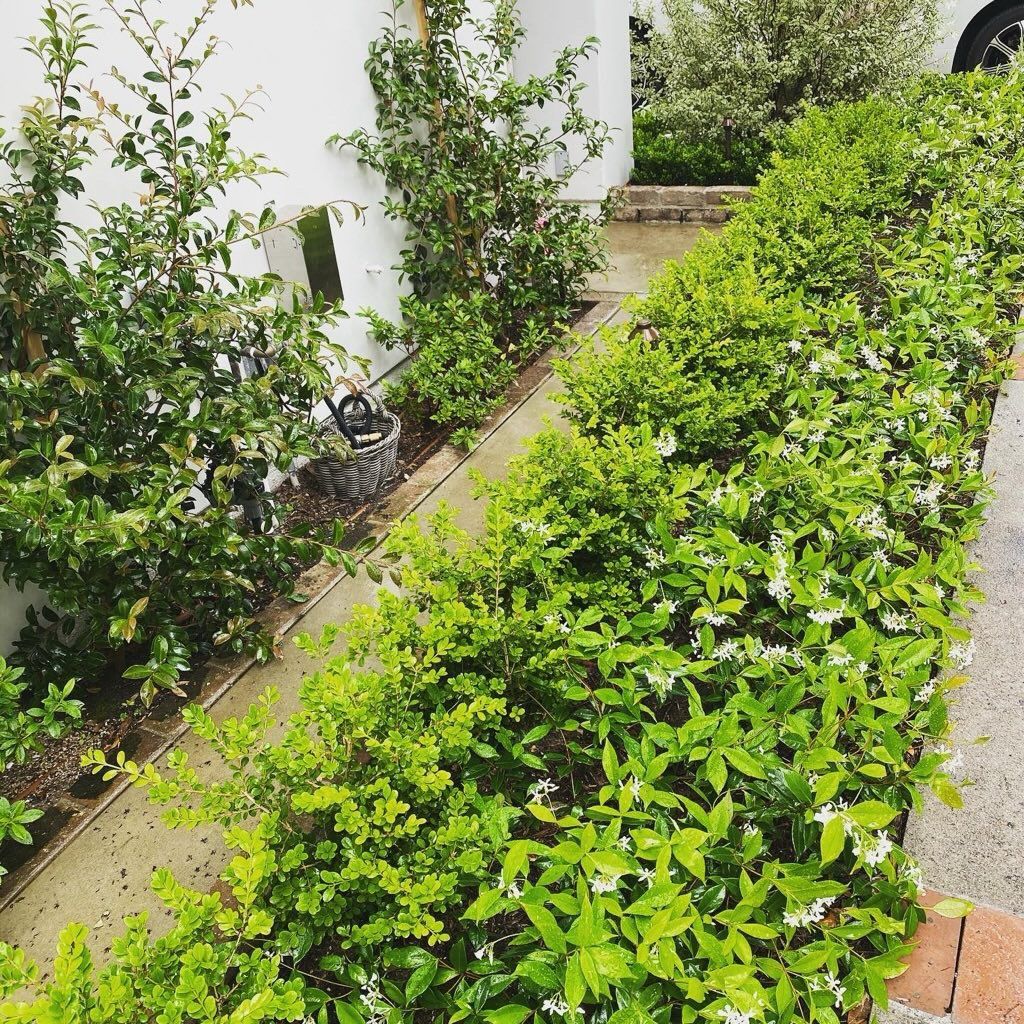 Two men are standing in a warehouse talking to each other.