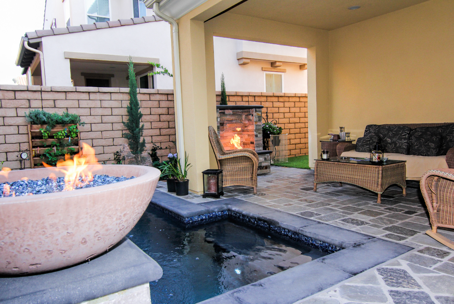 A patio with a fire pit and a swimming pool
