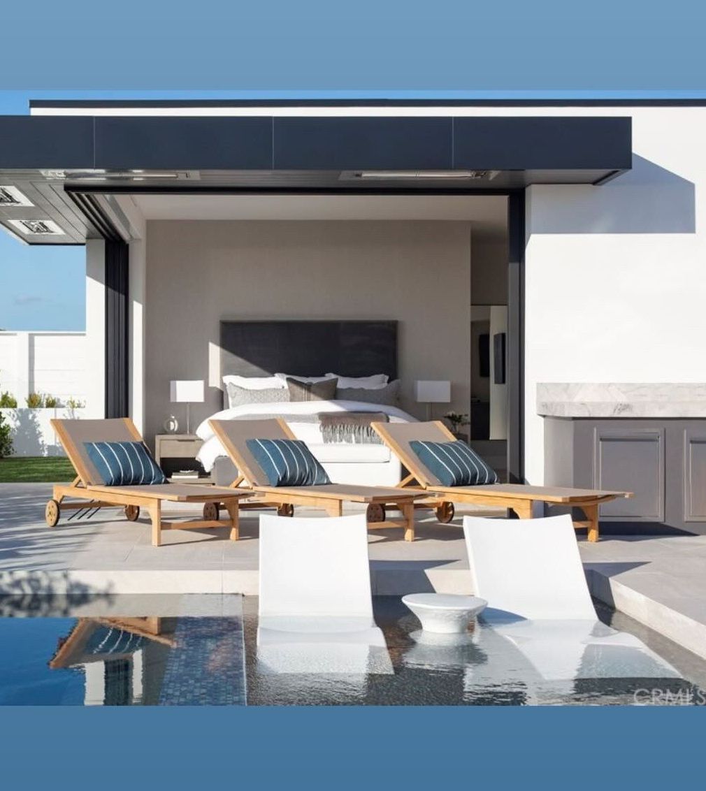 A bedroom with a large bed and a swimming pool