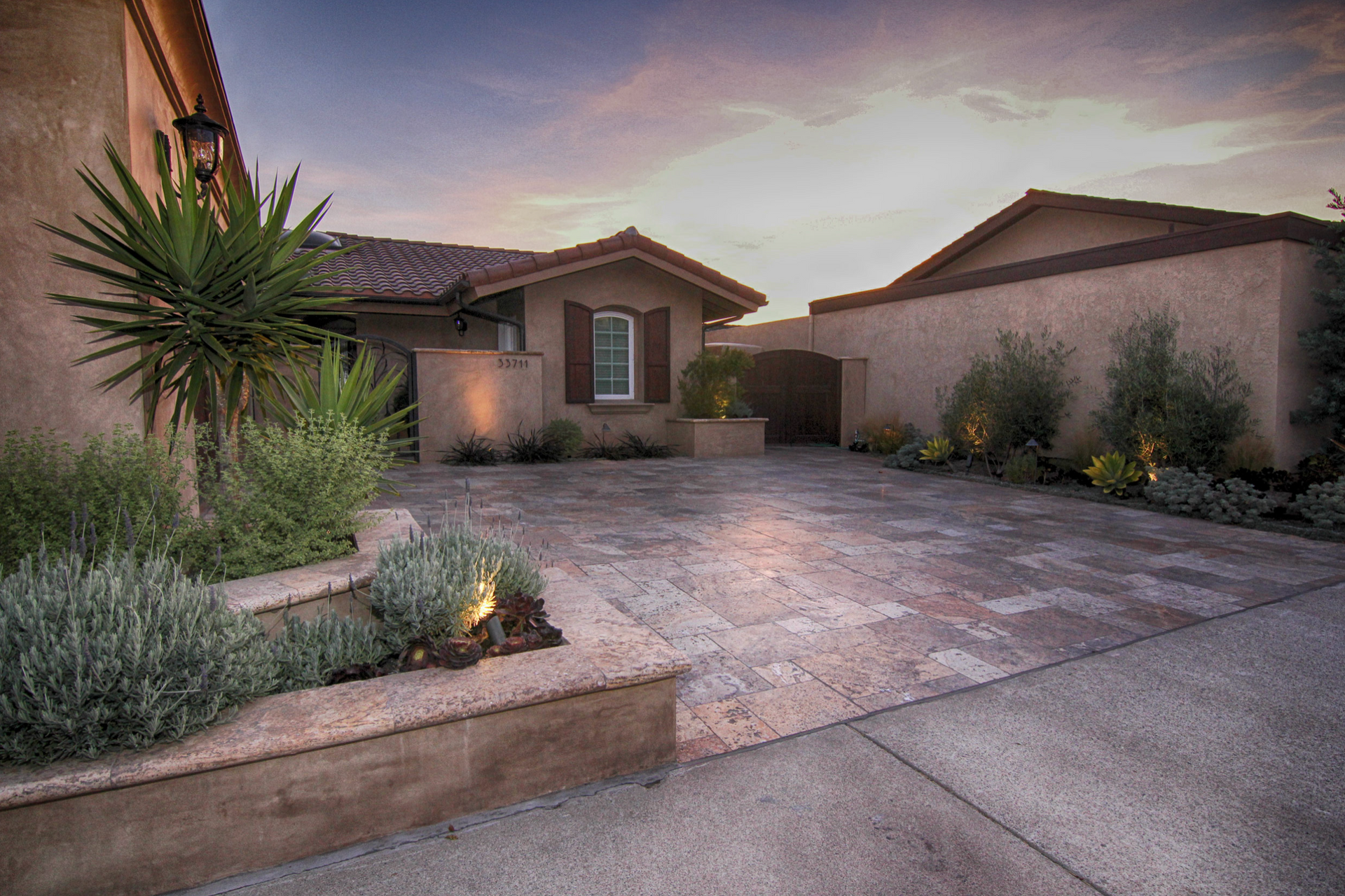 A large house with a large driveway in front of it.
