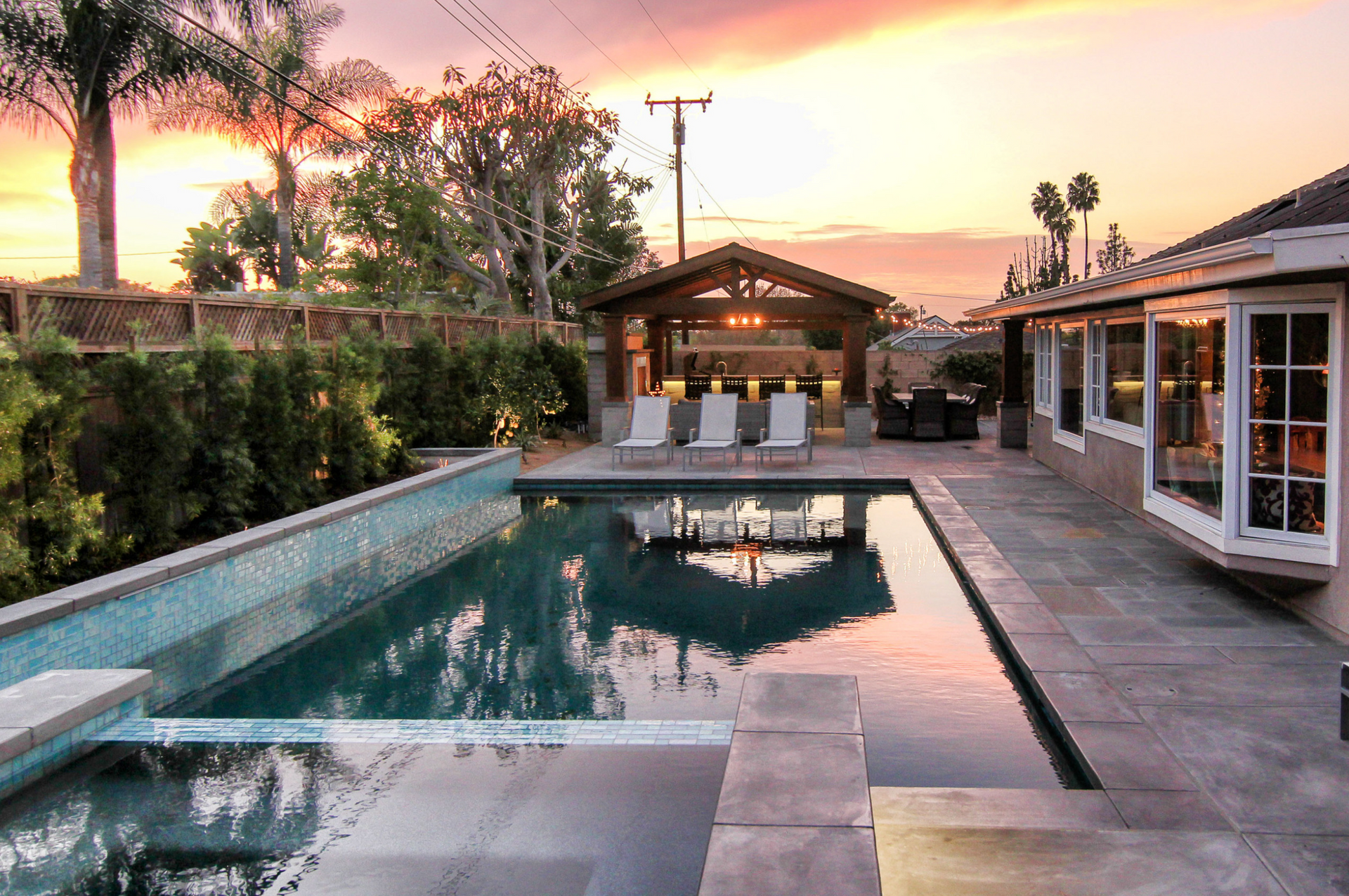 A large swimming pool in the backyard of a house