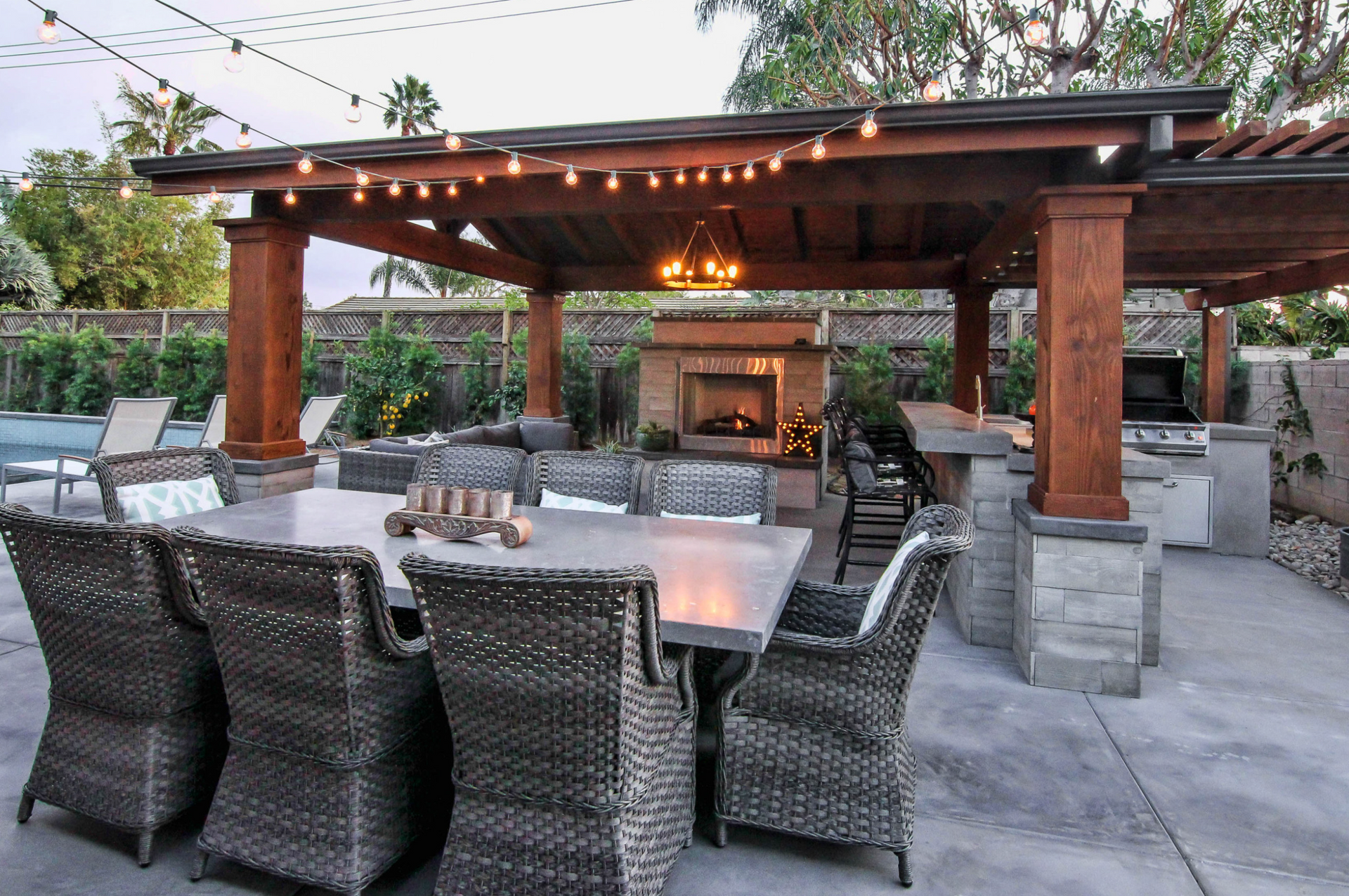 A patio with a table and chairs and a fireplace