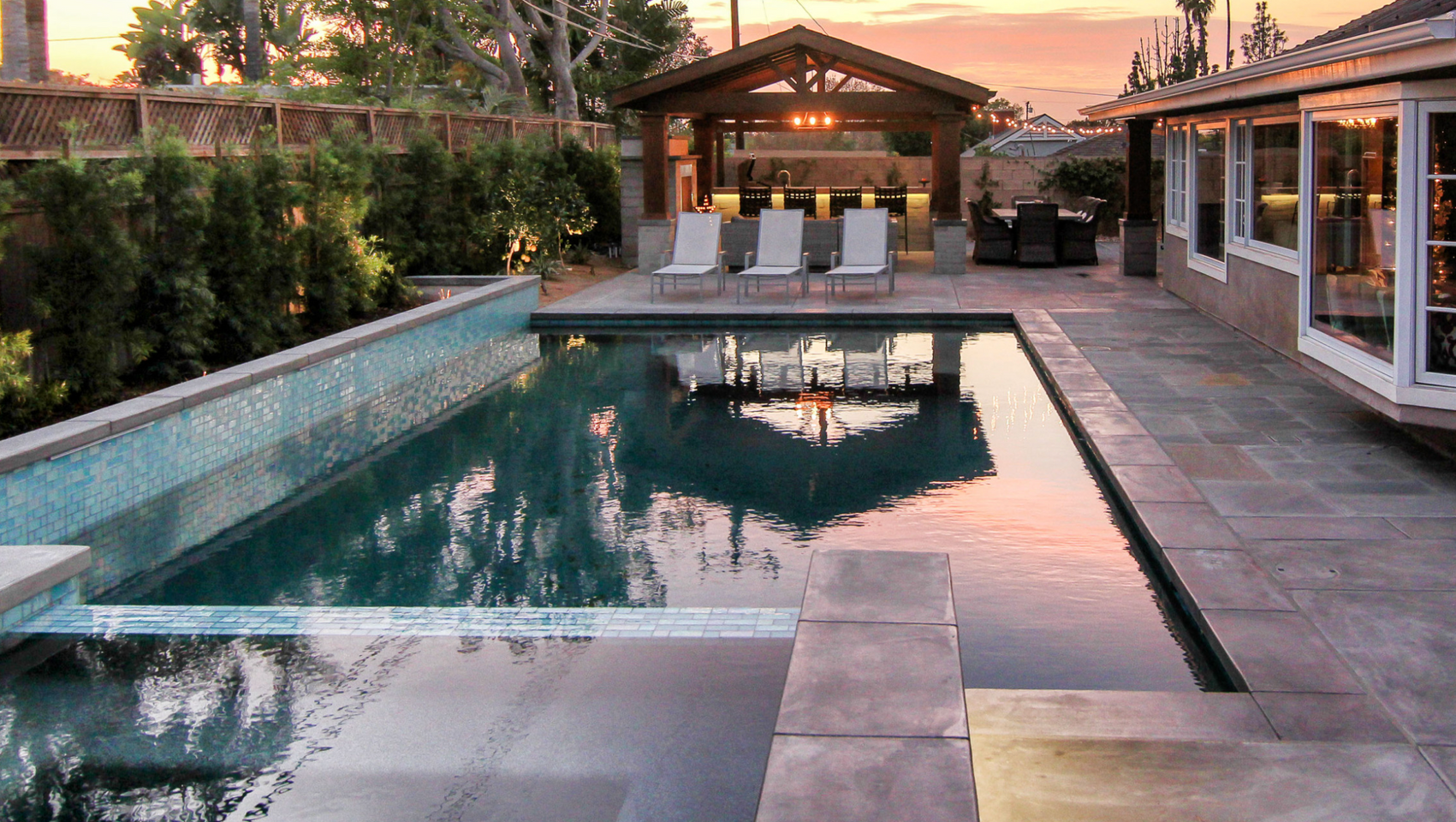 A large swimming pool in the backyard of a house