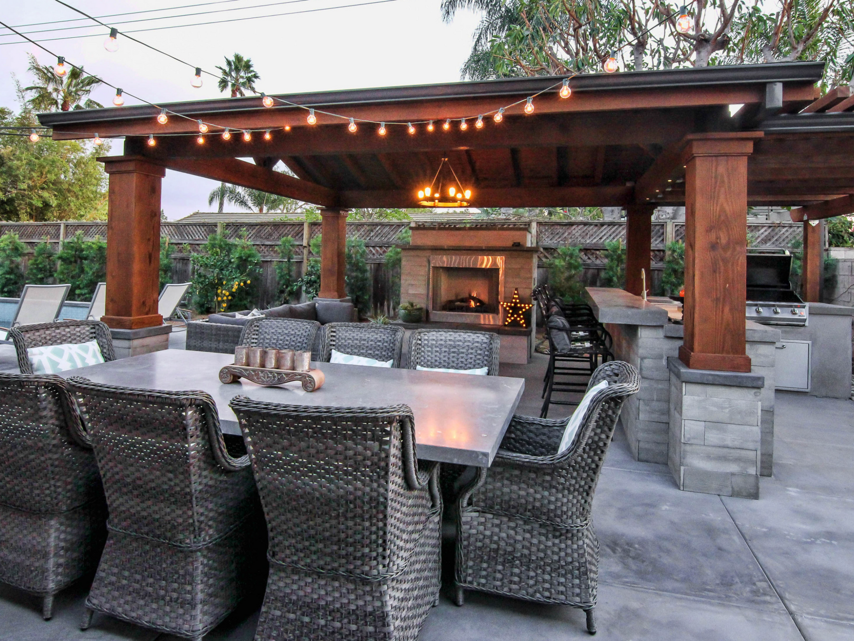 A patio area with a table and chairs and a fireplace