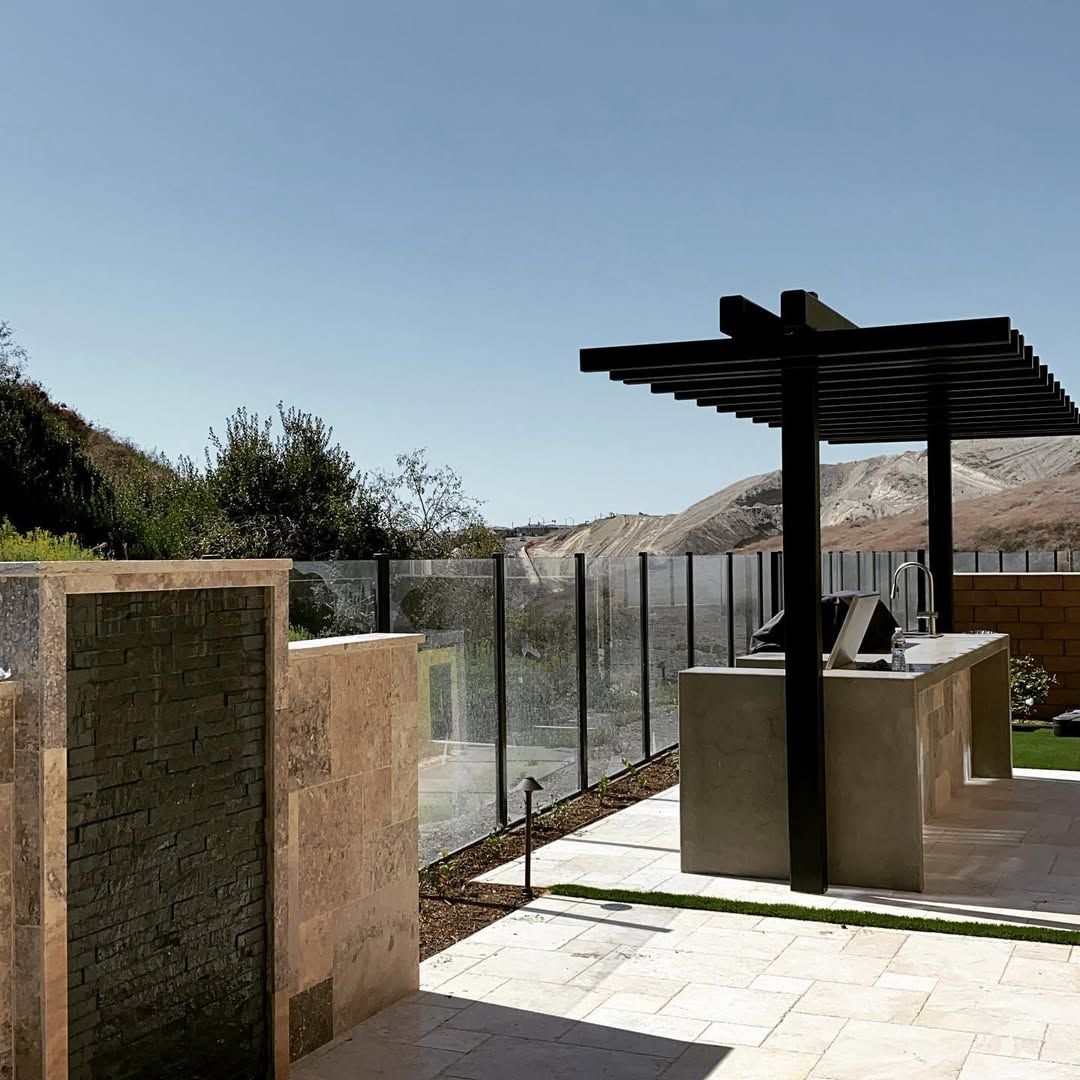 A patio area with a pergola and a table