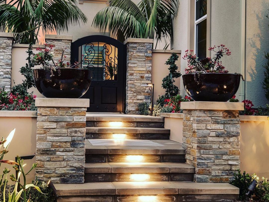 A set of stairs leading up to the front door of a house