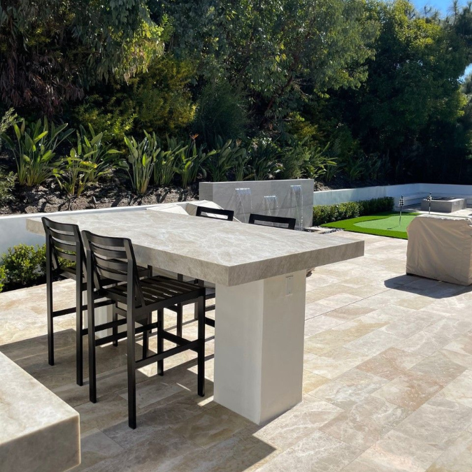 A patio with a table and chairs on it