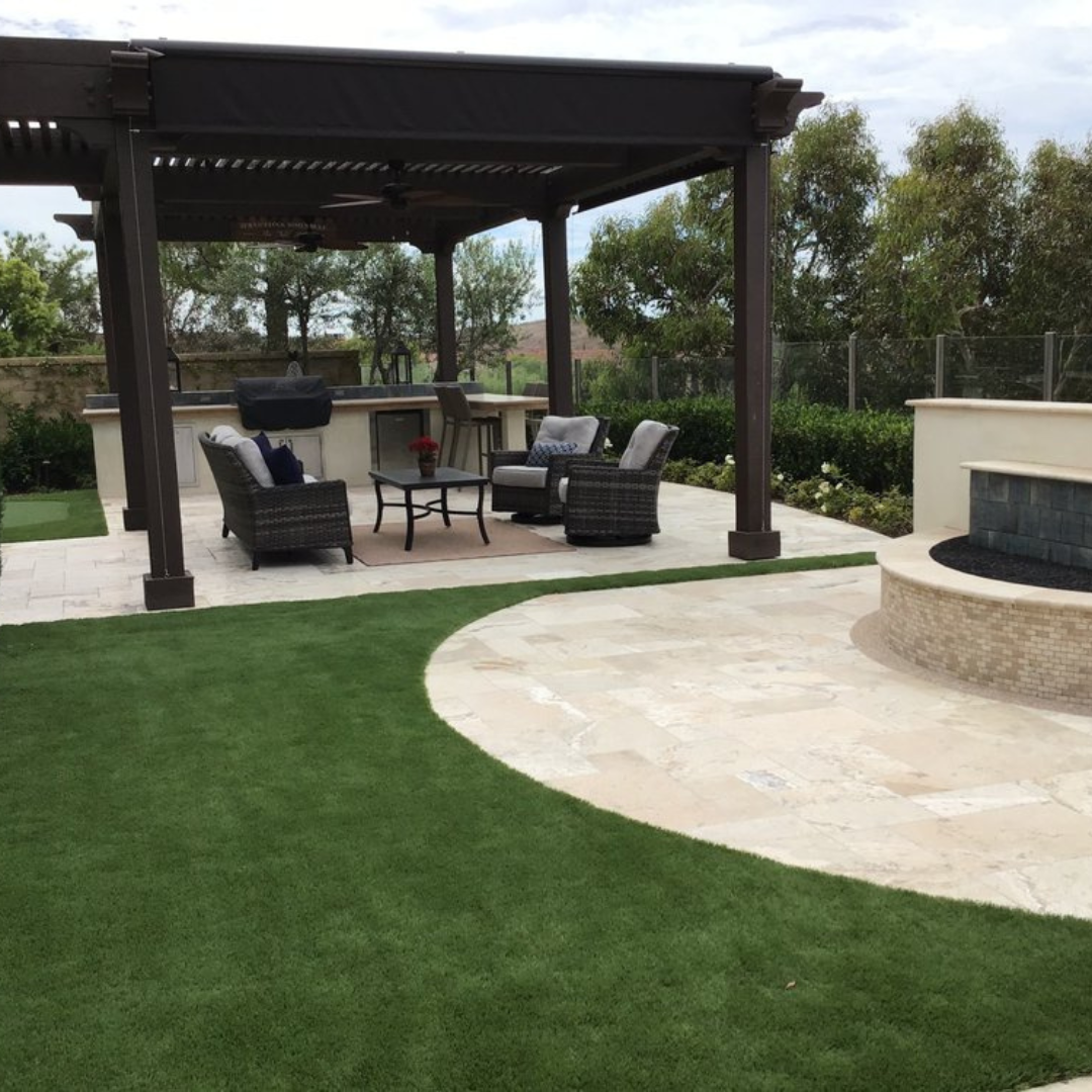 A patio area with a pergola and a fire pit