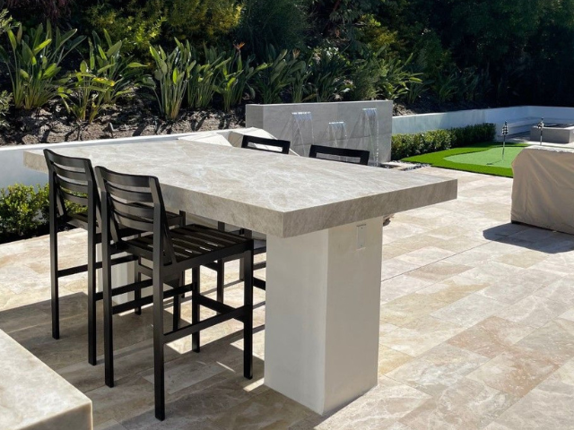 A patio with a table and chairs on it