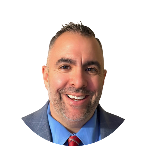 A man with a beard is wearing a suit and smiling