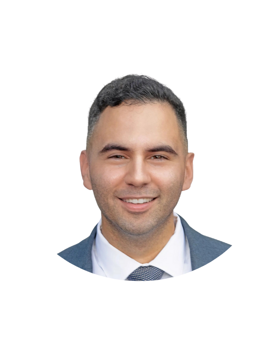 A man with a beard is wearing a suit and smiling