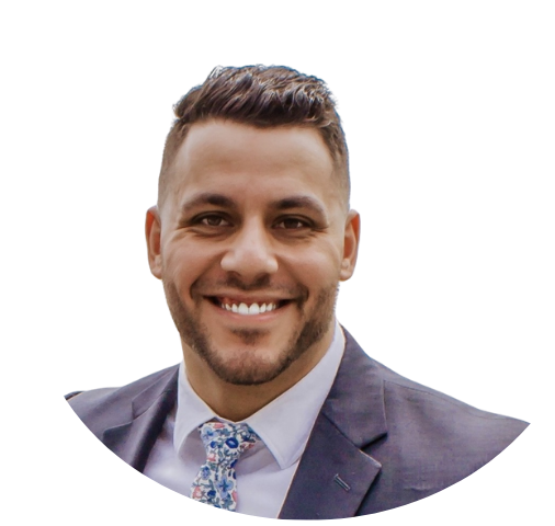 A man with a beard is wearing a suit and smiling