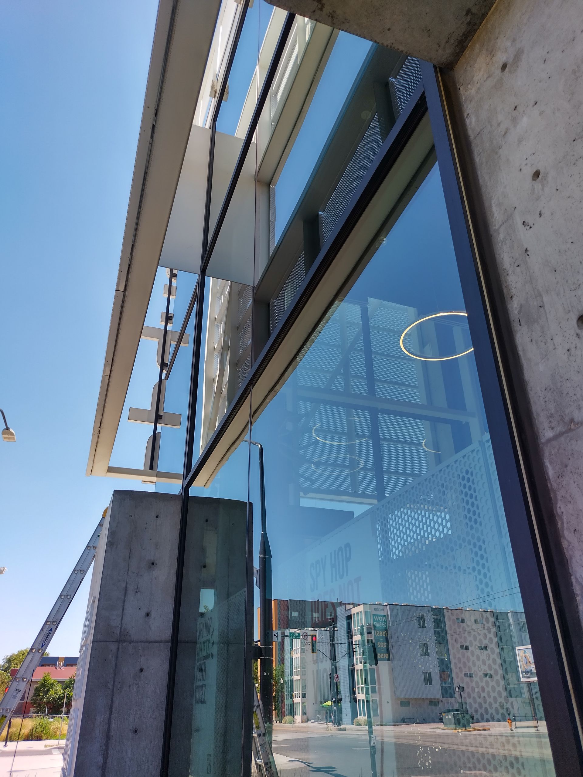 A man is opening a glass door with his hand.