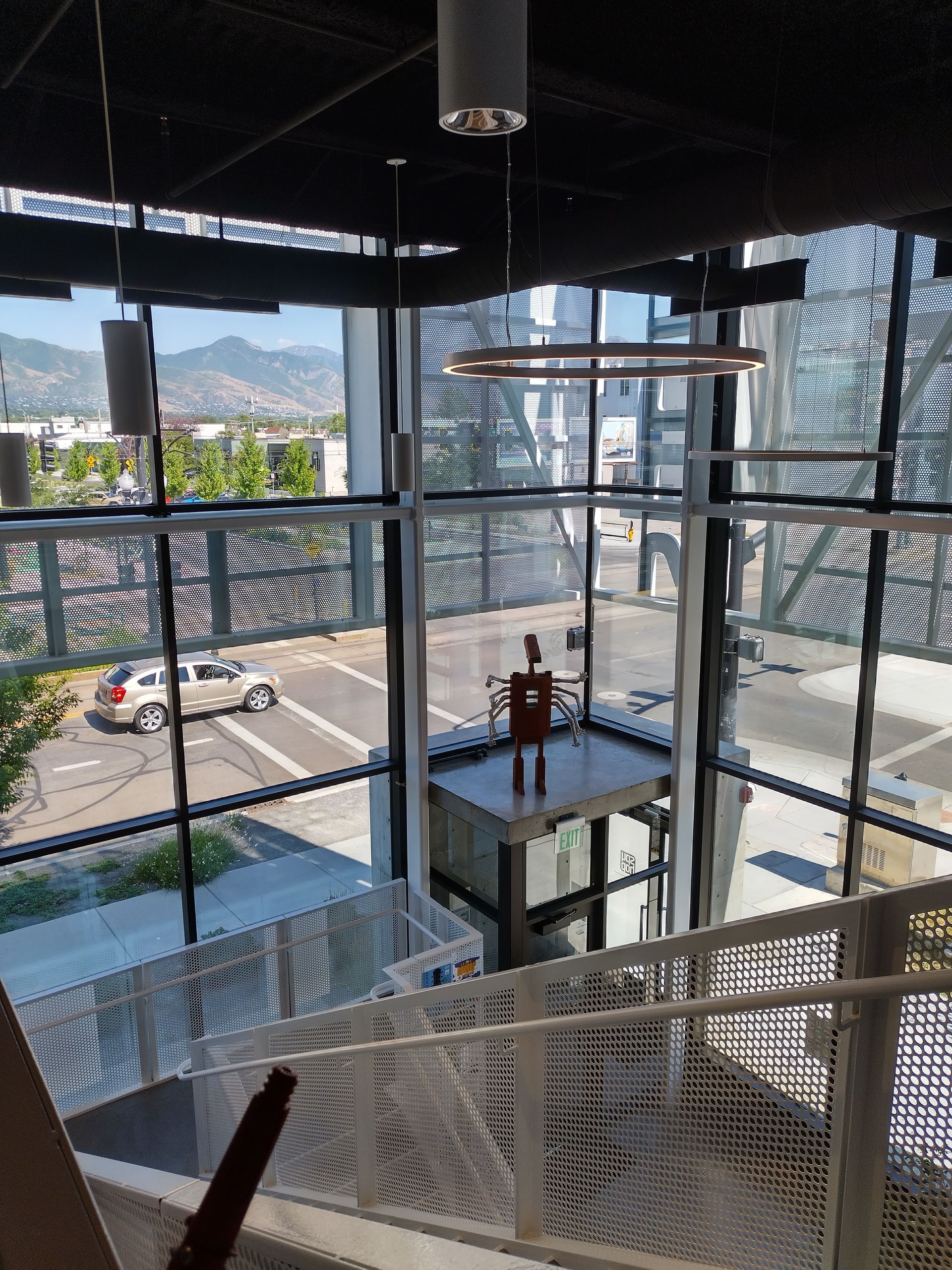 A view of a city from the second floor of a building.