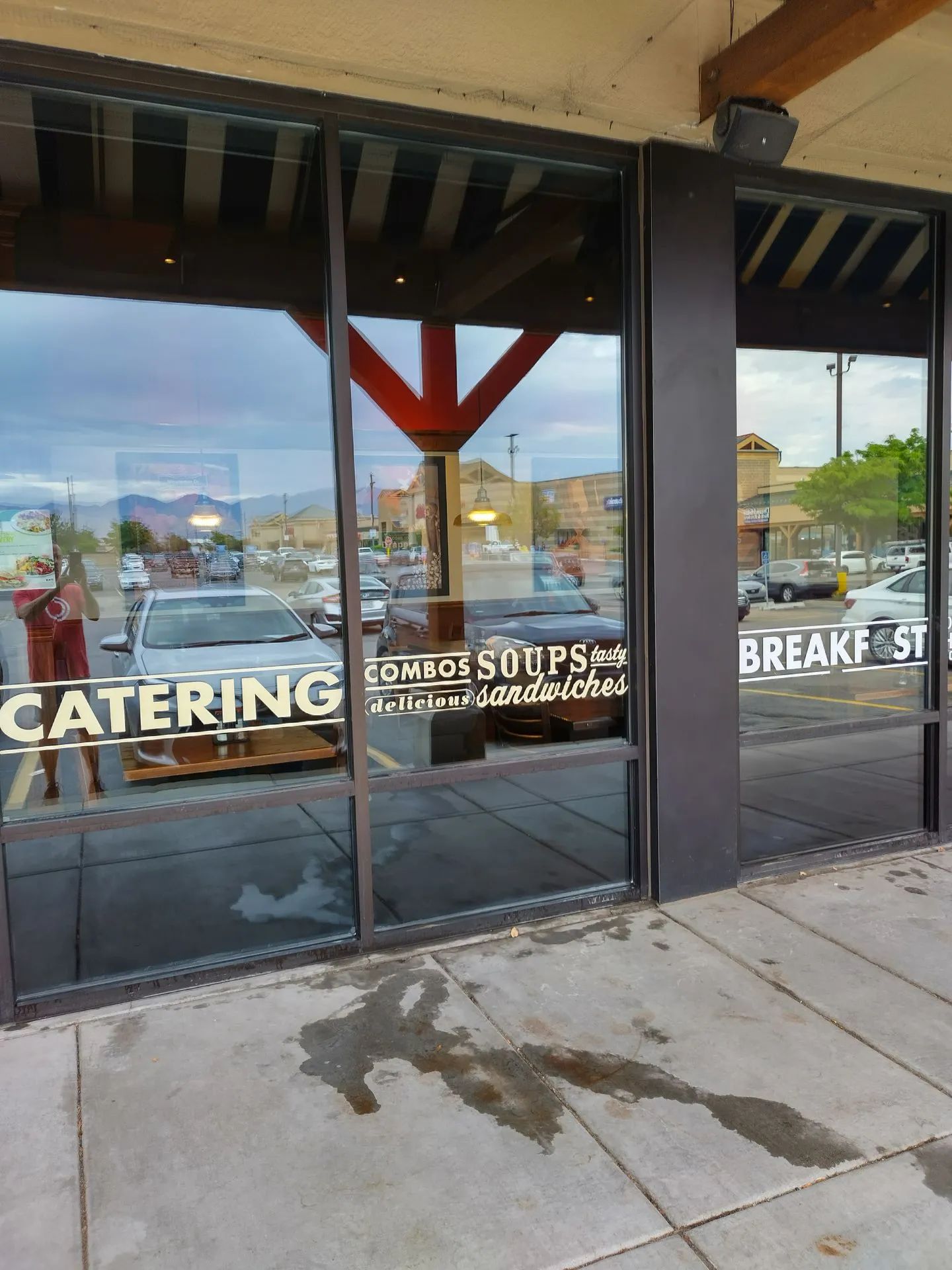 A catering sign is on the window of a restaurant