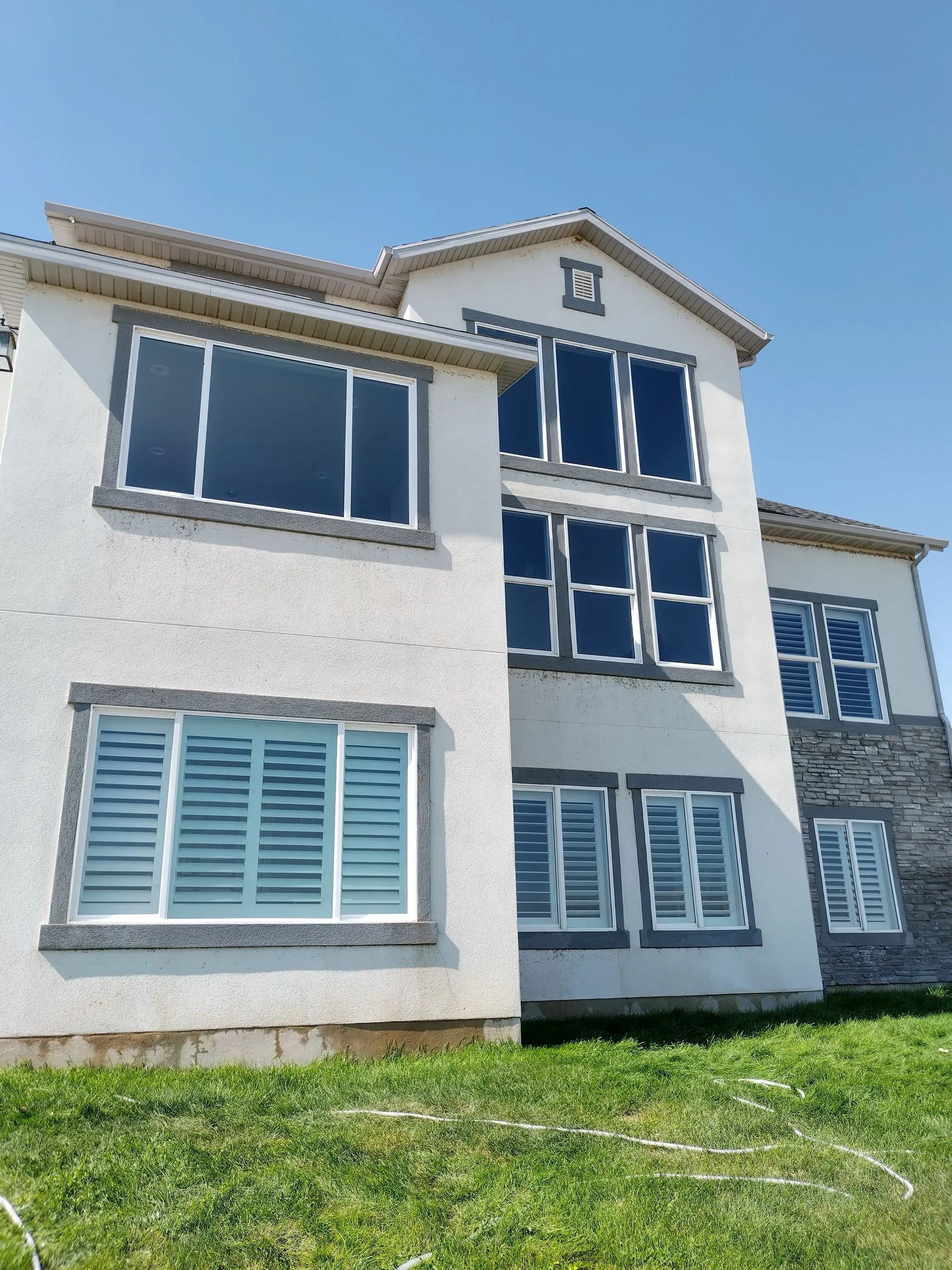 A large white building with lots of windows and shutters