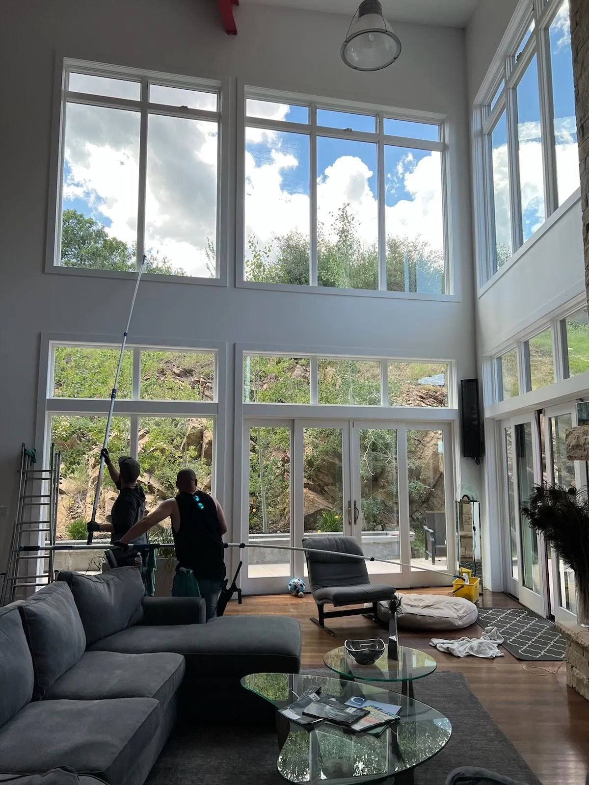 A living room with a lot of windows and a couch.