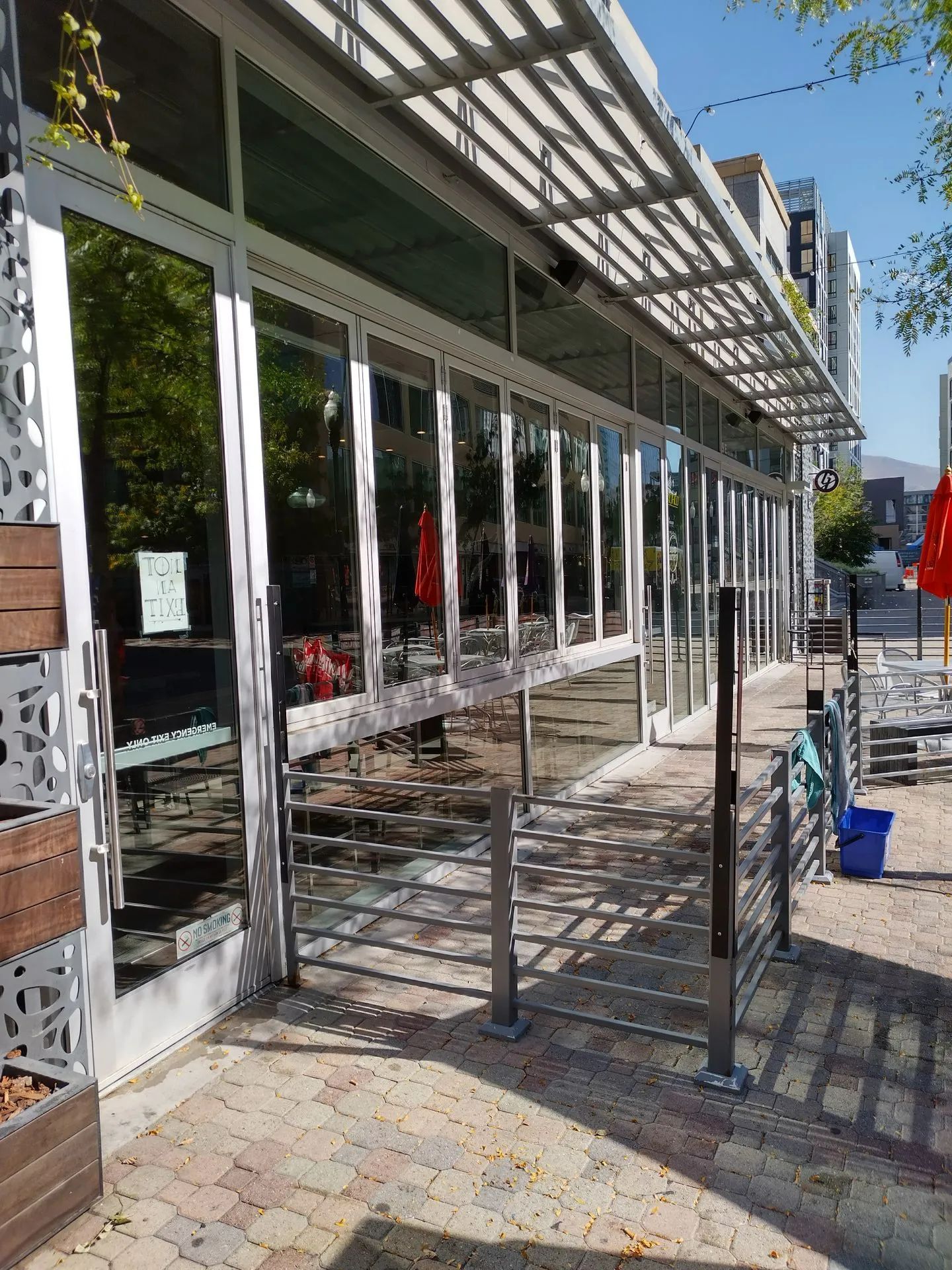 A large building with a lot of windows and umbrellas