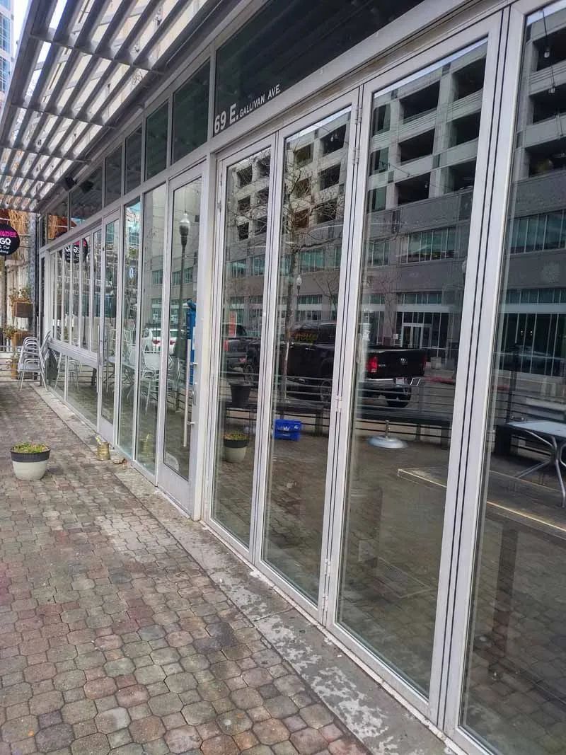 A building with a lot of windows and a reflection of a building in the windows.