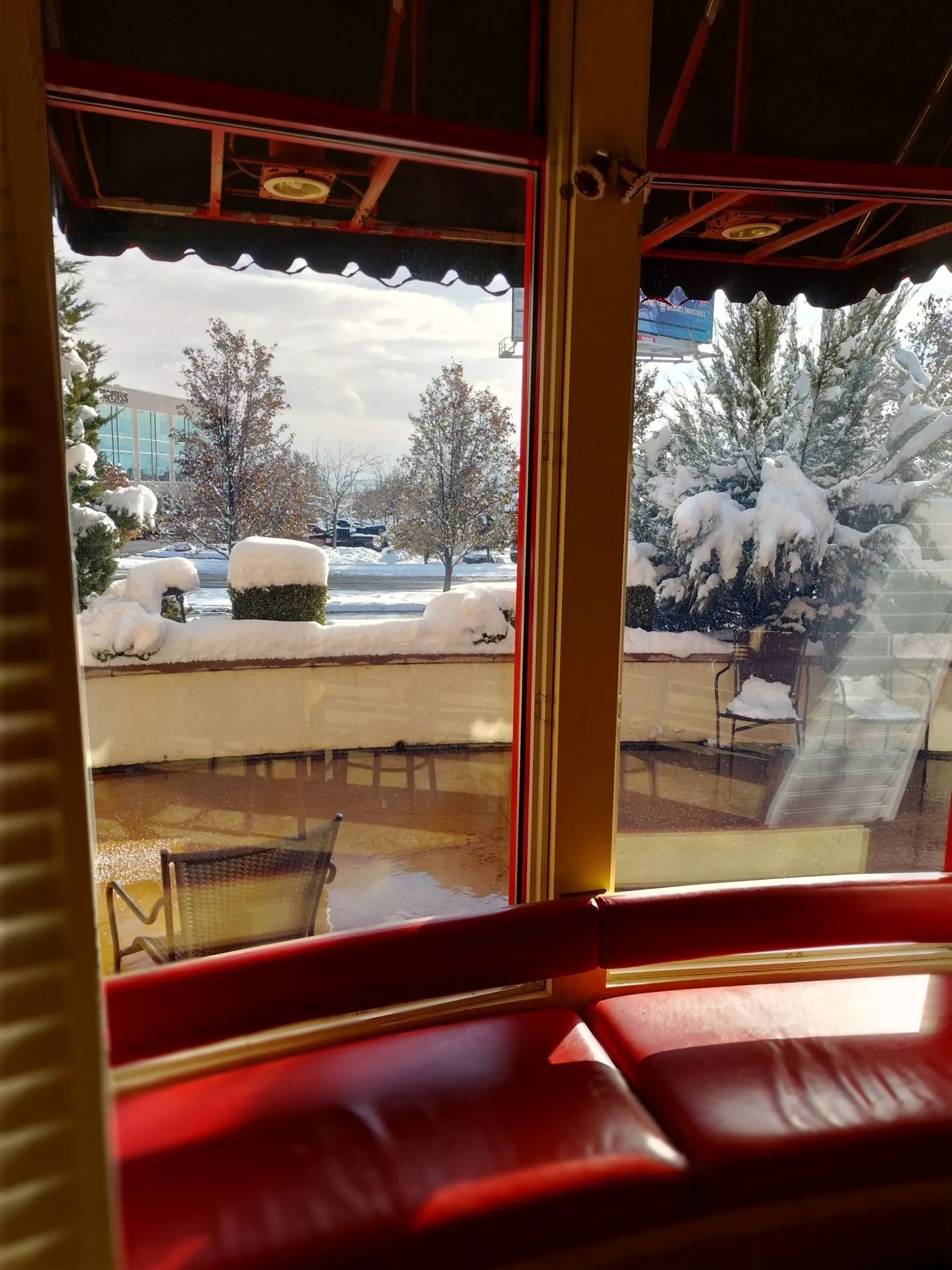A view of snow covered trees from a restaurant window