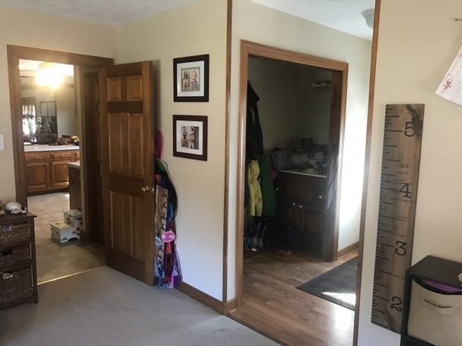 A room with a ruler on the wall and a picture on the wall