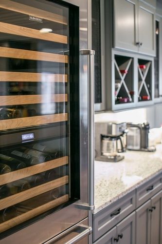 A kitchen with a wine cooler and a coffee maker.