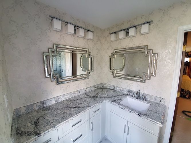 A bathroom with two sinks and two mirrors.