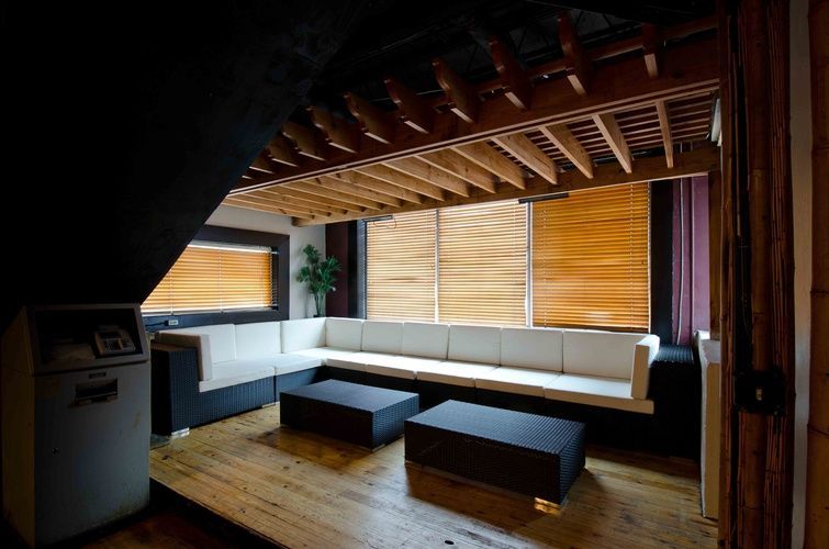 A living room with a couch and two tables