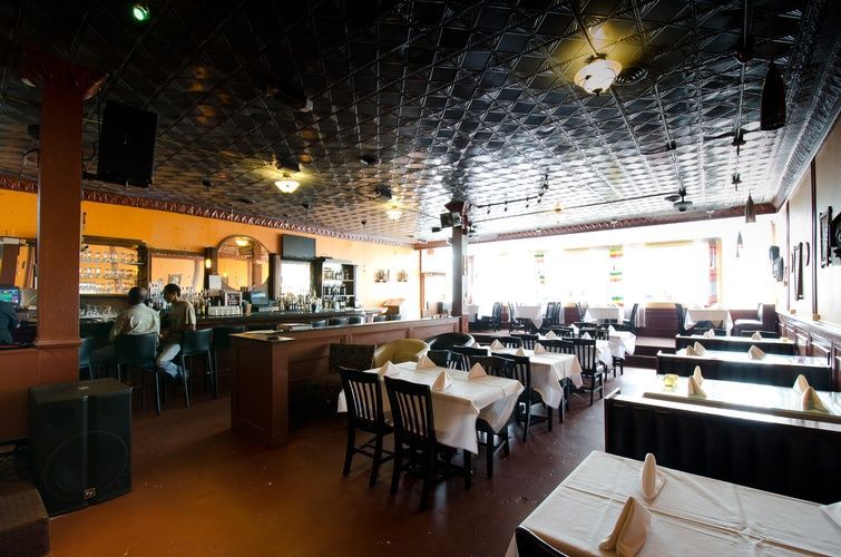 A restaurant with tables and chairs and a bar