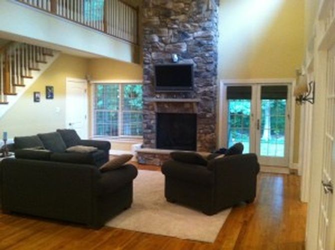 A living room with a couch and chairs and a fireplace