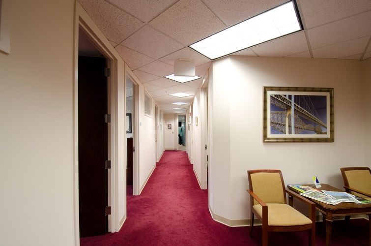 A long hallway with a picture of a bridge on the wall