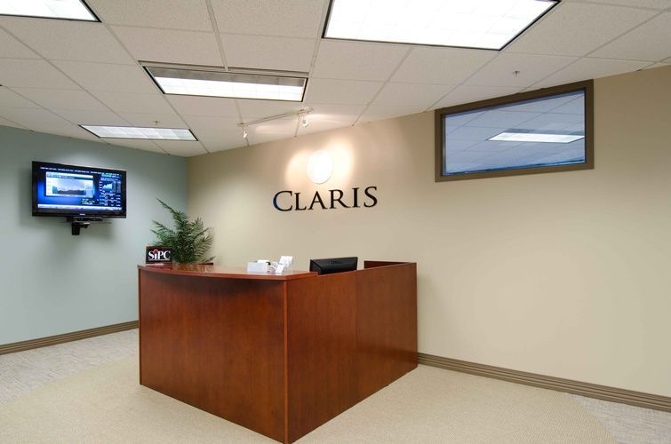 A claris sign hangs above a wooden desk