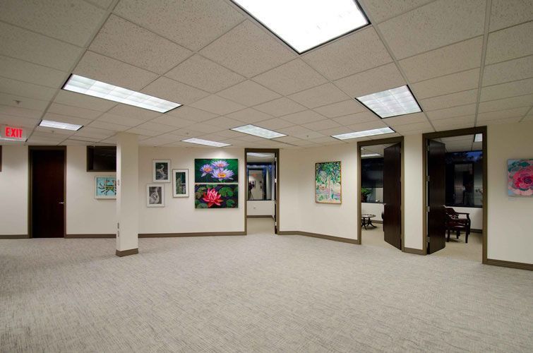 An empty room with a red exit sign on the ceiling