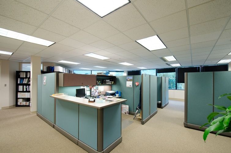 A large office with cubicles and a desk