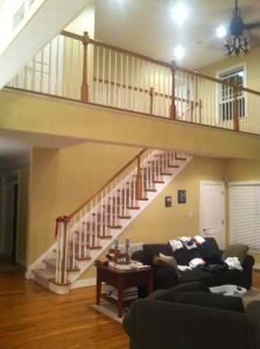 A living room with stairs leading up to the second floor