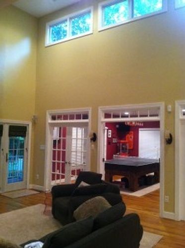 A living room with a pool table and a couch